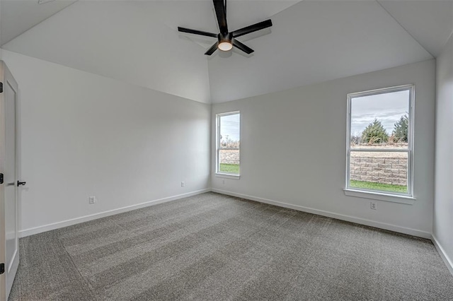 spare room with carpet, vaulted ceiling, and plenty of natural light