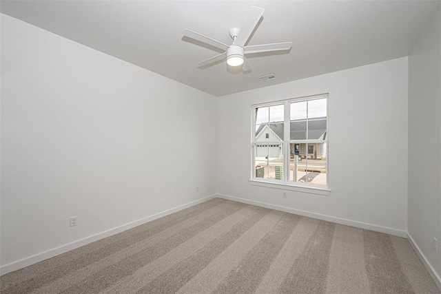 spare room with carpet flooring and ceiling fan