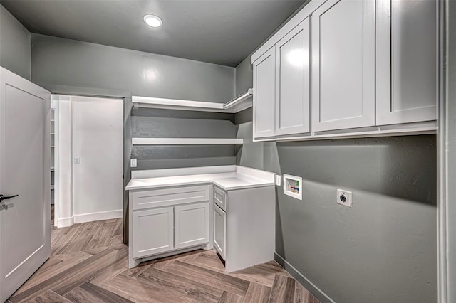 laundry area with electric dryer hookup, hookup for a washing machine, cabinets, and parquet flooring