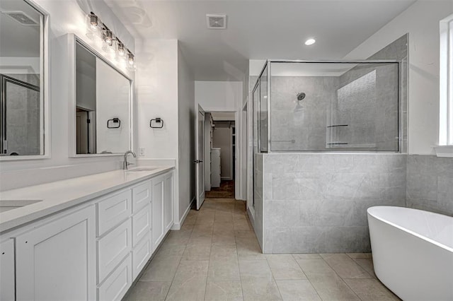 bathroom featuring tile patterned floors, vanity, and plus walk in shower