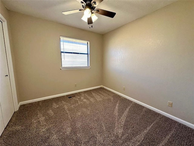 unfurnished room featuring ceiling fan and carpet floors