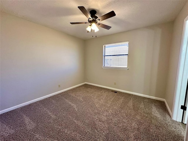 carpeted empty room featuring ceiling fan and a textured ceiling