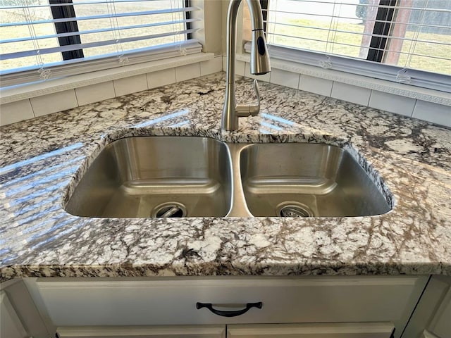 details featuring sink and stone countertops