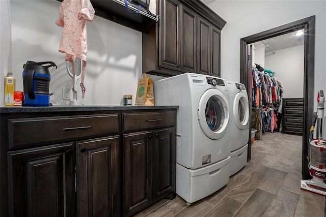 laundry room featuring cabinets and separate washer and dryer