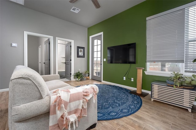 living room with hardwood / wood-style flooring and ceiling fan