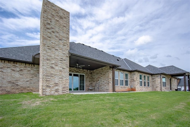 back of property with a lawn, ceiling fan, and a patio