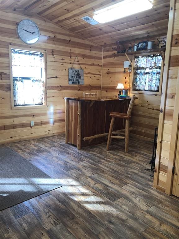 bar featuring dark hardwood / wood-style floors, wood walls, wooden ceiling, and vaulted ceiling