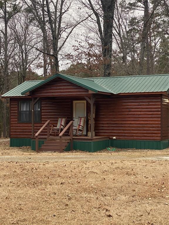 log cabin with covered porch