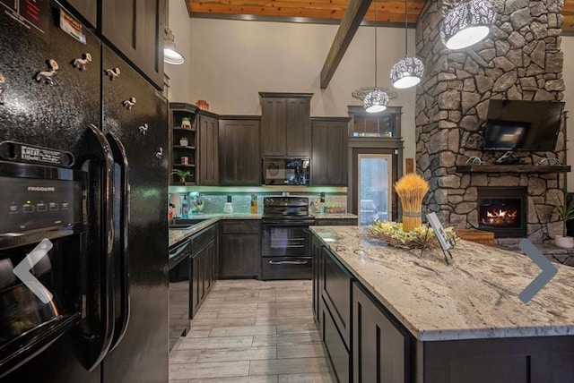 kitchen with dark brown cabinetry, light stone countertops, beamed ceiling, black appliances, and light wood-type flooring