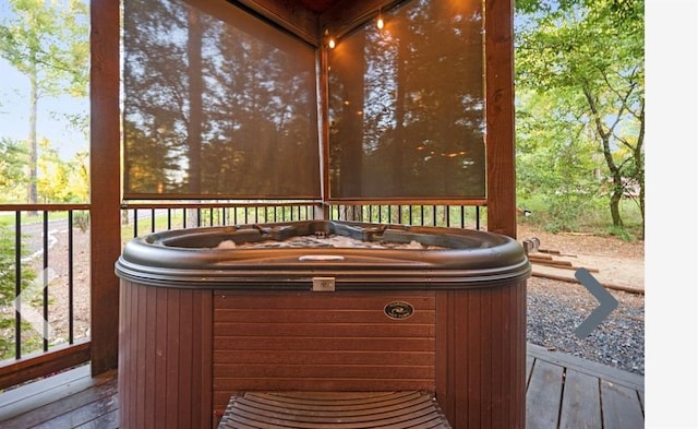 wooden deck featuring a hot tub