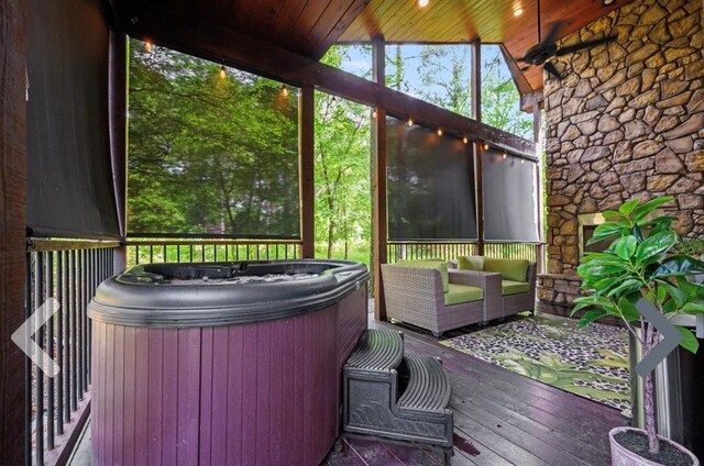 unfurnished sunroom featuring a jacuzzi, wood ceiling, and lofted ceiling