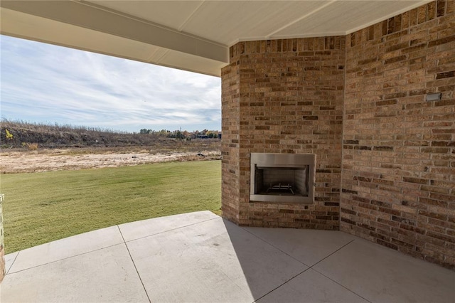 view of patio featuring an outdoor brick fireplace