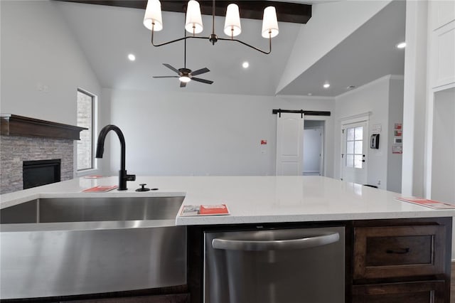 kitchen featuring ceiling fan, a barn door, lofted ceiling with beams, dishwasher, and hanging light fixtures