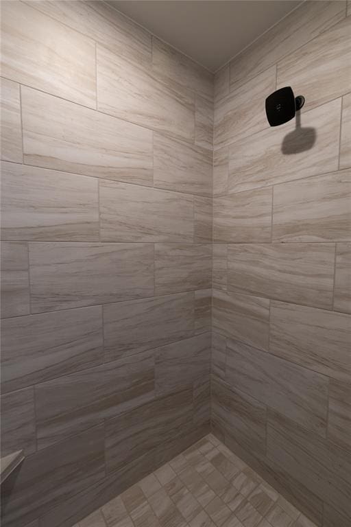 bathroom with a tile shower