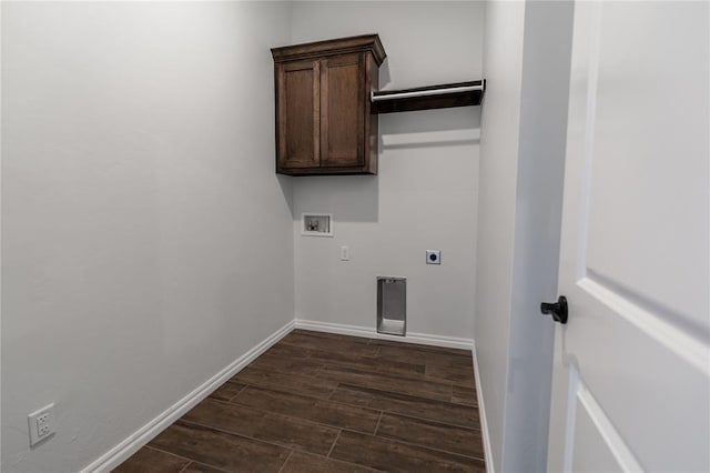 clothes washing area with electric dryer hookup, hookup for a washing machine, dark hardwood / wood-style flooring, and cabinets