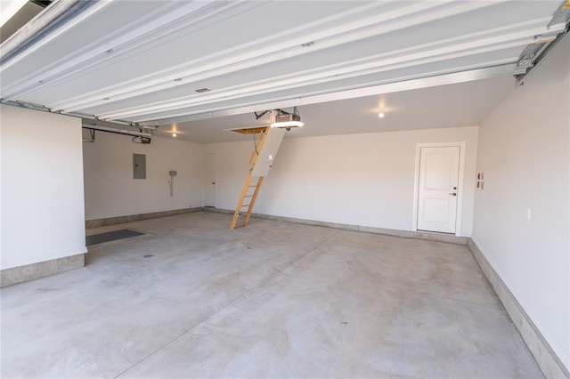 garage with electric panel and a garage door opener