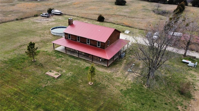 birds eye view of property with a rural view