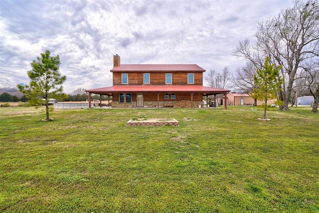 exterior space featuring covered porch and a yard