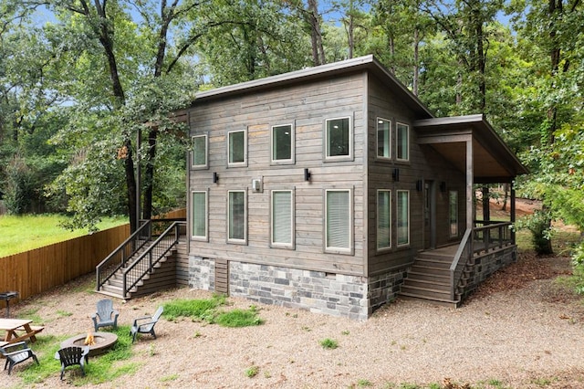 view of home's exterior featuring a fire pit