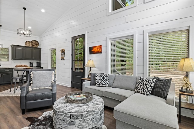 living room with wooden walls, high vaulted ceiling, and dark wood-type flooring