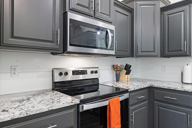 kitchen featuring stainless steel appliances and gray cabinetry