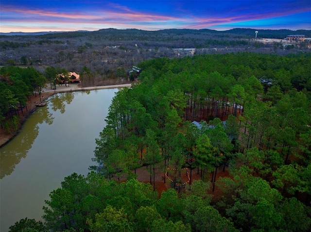 aerial view at dusk featuring a water and mountain view