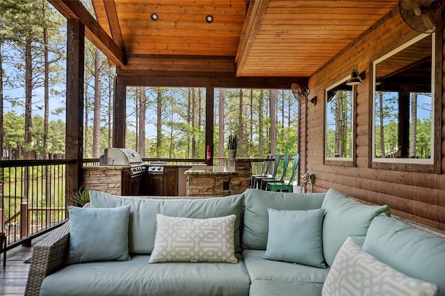 sunroom / solarium with a wealth of natural light and wood ceiling