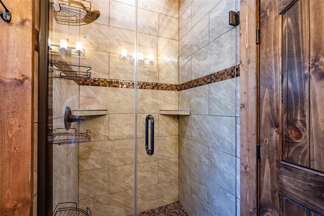 bathroom featuring a shower with door