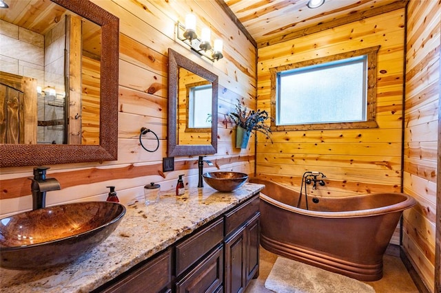 bathroom with vanity, a bathtub, wood ceiling, and wooden walls