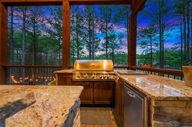 patio terrace at dusk featuring area for grilling