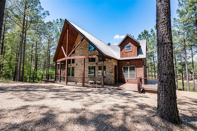 rear view of house with a wooden deck