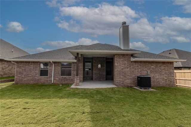 back of property featuring a lawn, central AC, and a patio area