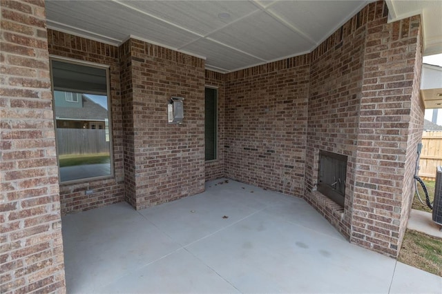 view of patio / terrace featuring an outdoor brick fireplace