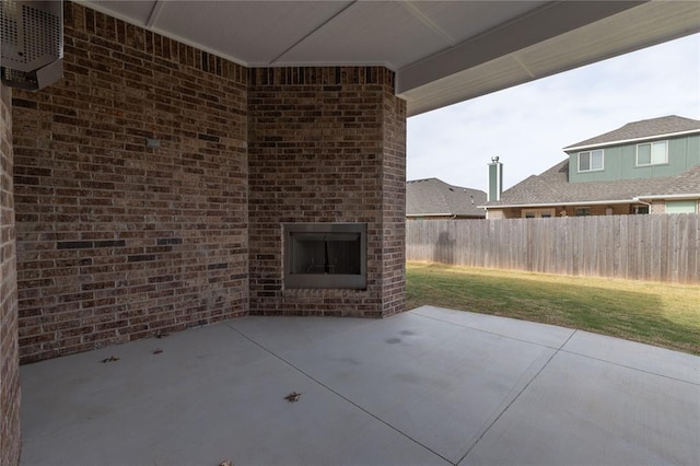 view of patio / terrace featuring an outdoor brick fireplace