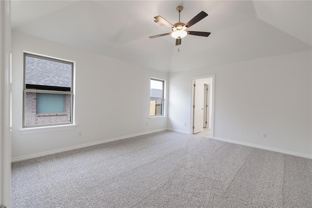 carpeted empty room featuring ceiling fan and lofted ceiling