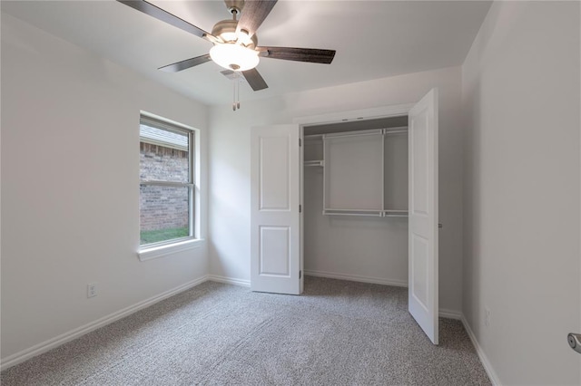 unfurnished bedroom featuring carpet floors, a closet, and ceiling fan