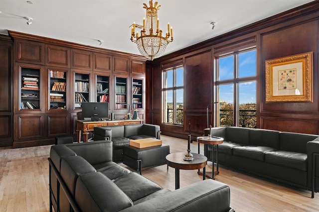 interior space with wooden walls, light hardwood / wood-style flooring, and a notable chandelier