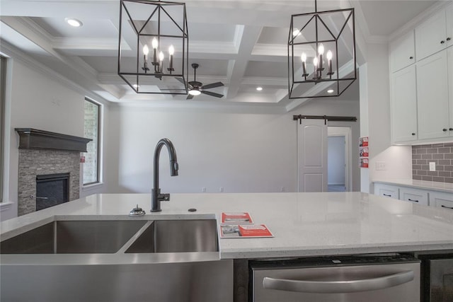 8800 Tyrion Dr, Edmond, OK 73007 - kitchen with a chandelier, coffered ceiling, ceiling fan, a barn door, and stainless steel dishwasher