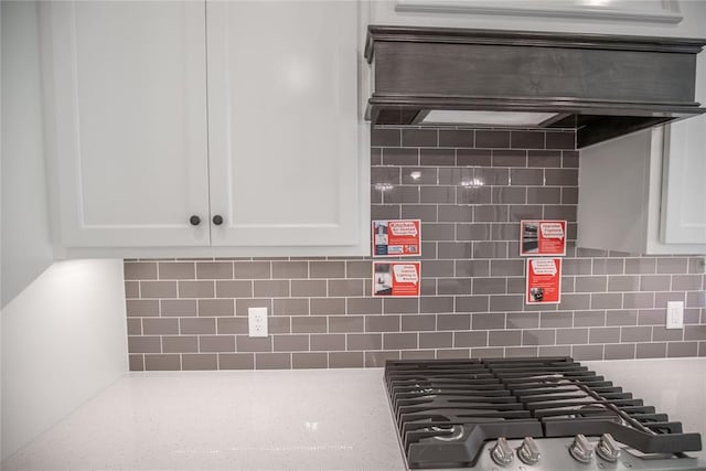 8800 Tyrion Dr, Edmond, OK 73007 - kitchen view of white cabinets, tasteful backsplash, and stainless steel gas cooktop
