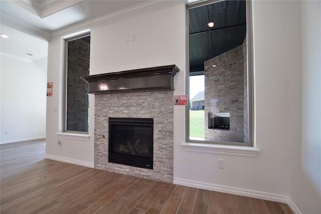 8800 Tyrion Dr, Edmond, OK 73007 - unfurnished living room with a fireplace, wood finished floors, and ornamental molding