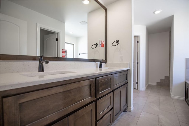 8800 Tyrion Dr, Edmond, OK 73007 - bathroom featuring double vanity and baseboards