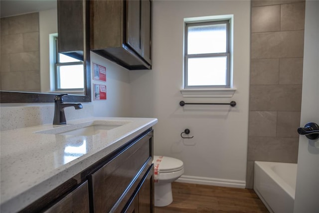 8800 Tyrion Dr, Edmond, OK 73007 - full bathroom with vanity, wood finished floors, and shower / bathtub combination