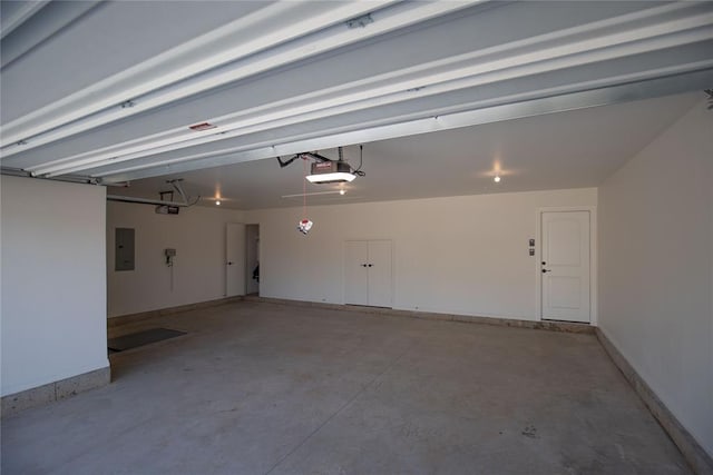 8800 Tyrion Dr, Edmond, OK 73007 - garage with electric panel and a garage door opener