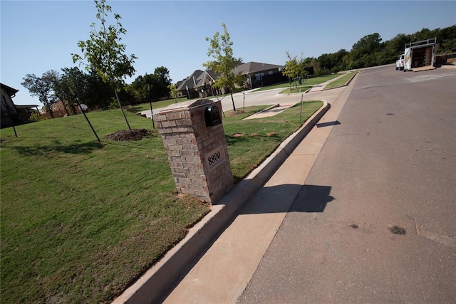 8800 Tyrion Dr, Edmond, OK 73007 - view of asphalt road featuring curbs