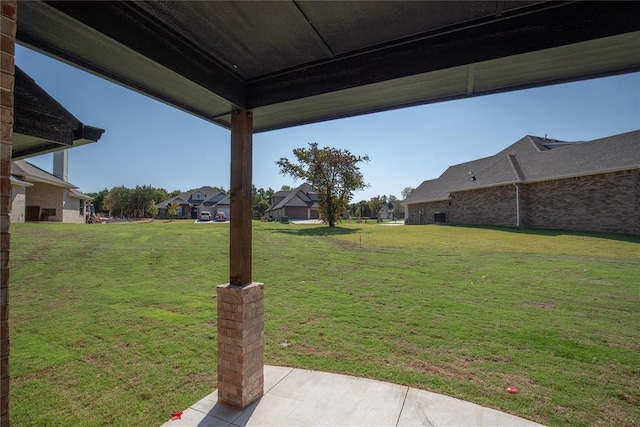 8800 Tyrion Dr, Edmond, OK 73007 - view of grassy yard with a patio and a residential view