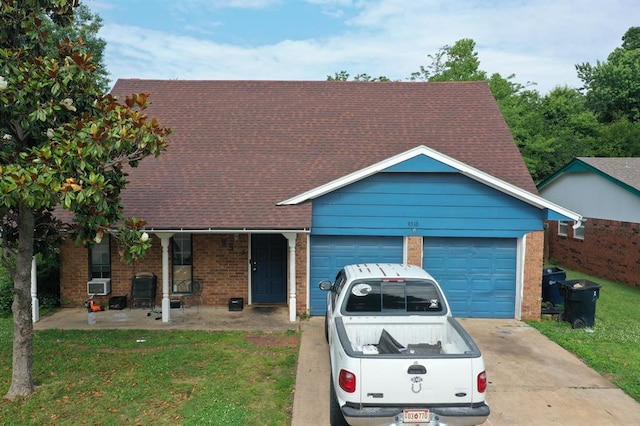 view of front of property with a garage, a front lawn, and cooling unit