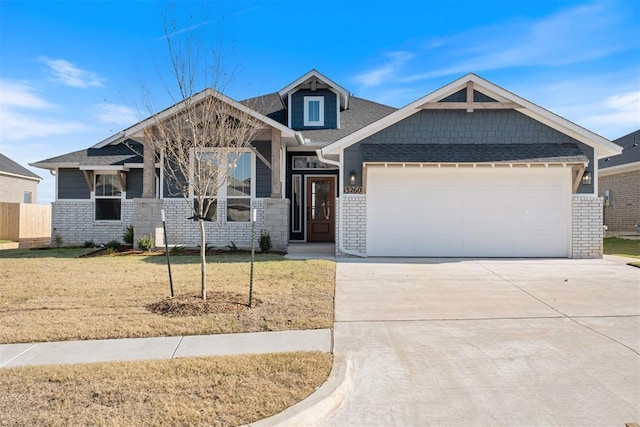 craftsman inspired home with a front yard and a garage