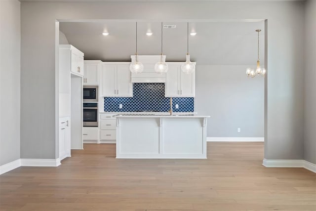 kitchen with light hardwood / wood-style flooring, white cabinetry, built in microwave, and stainless steel oven