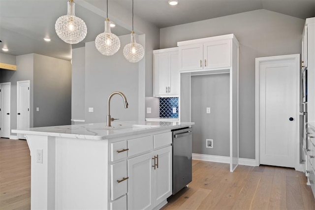 kitchen with a kitchen island with sink, sink, white cabinets, and pendant lighting