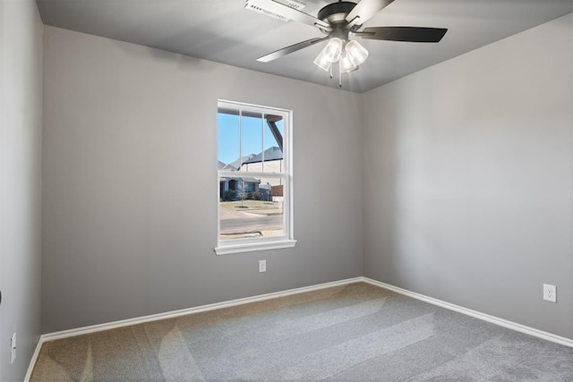 spare room featuring carpet flooring and ceiling fan